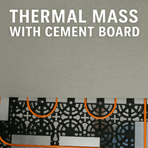 Half-covered radiant floor heating system with orange PEX tubing, aluminum heat plates, and cement board acting as thermal mass.